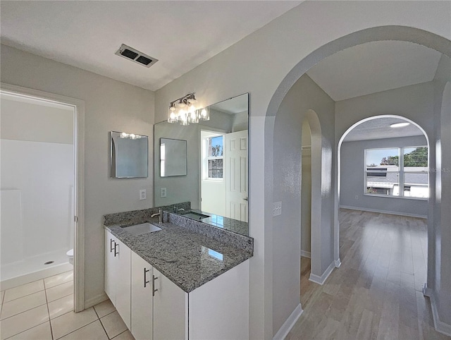 bathroom with hardwood / wood-style floors, vanity, and toilet