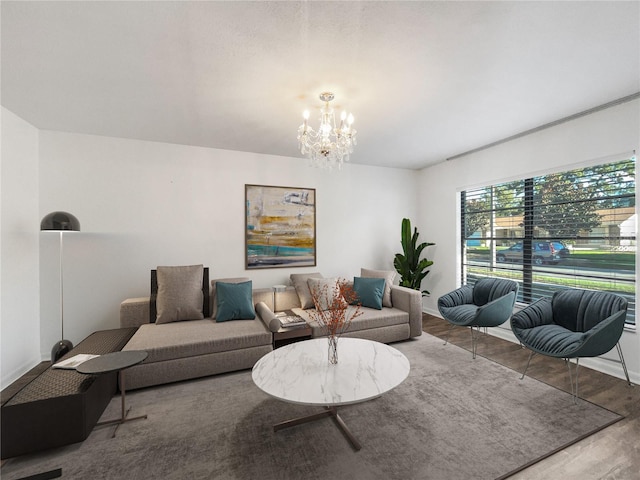 living room with wood-type flooring and a notable chandelier