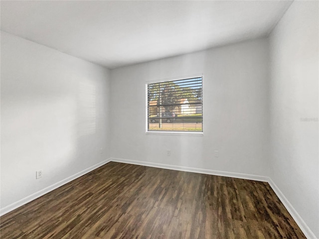 spare room with dark wood-type flooring