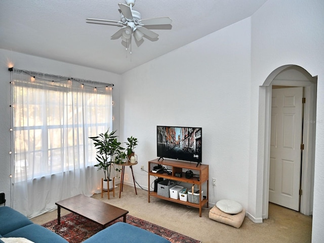 carpeted living room featuring ceiling fan