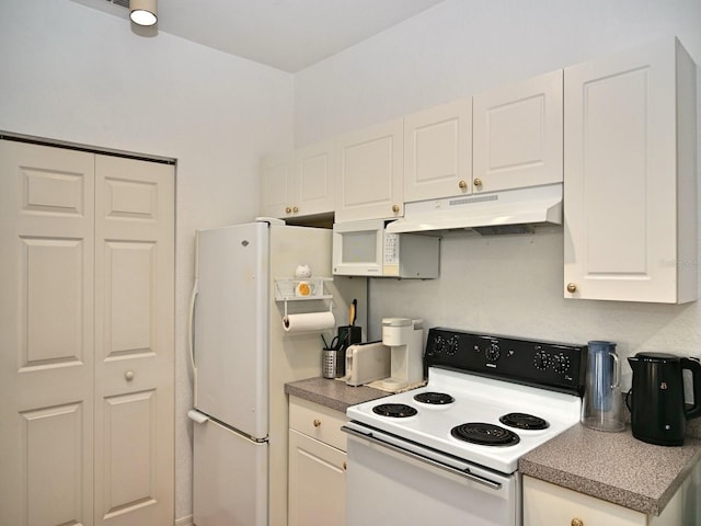 kitchen featuring white appliances and white cabinetry