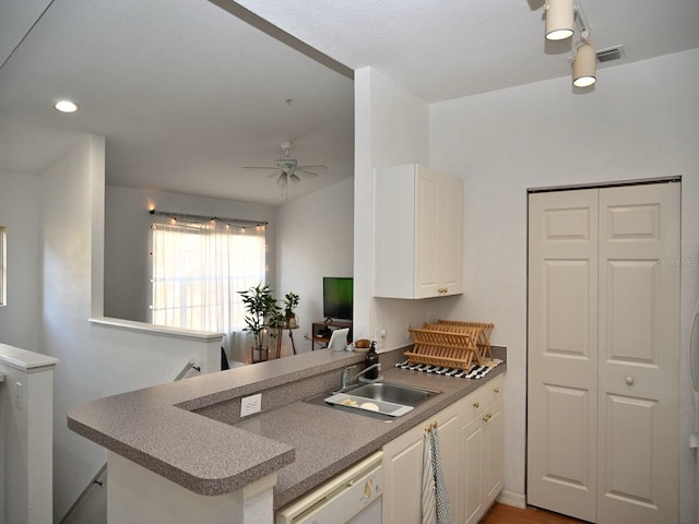 kitchen with white cabinetry, sink, ceiling fan, kitchen peninsula, and white dishwasher