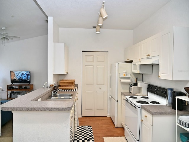 kitchen with white cabinets, white appliances, kitchen peninsula, and light hardwood / wood-style flooring