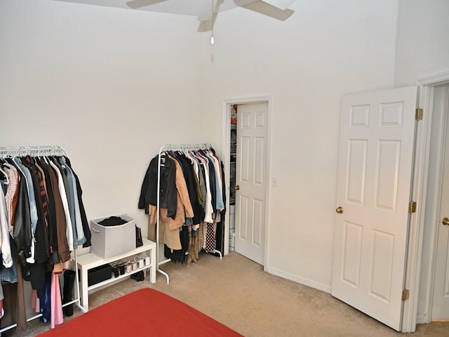 walk in closet with carpet and ceiling fan