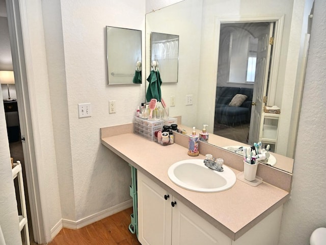 bathroom featuring vanity and hardwood / wood-style flooring