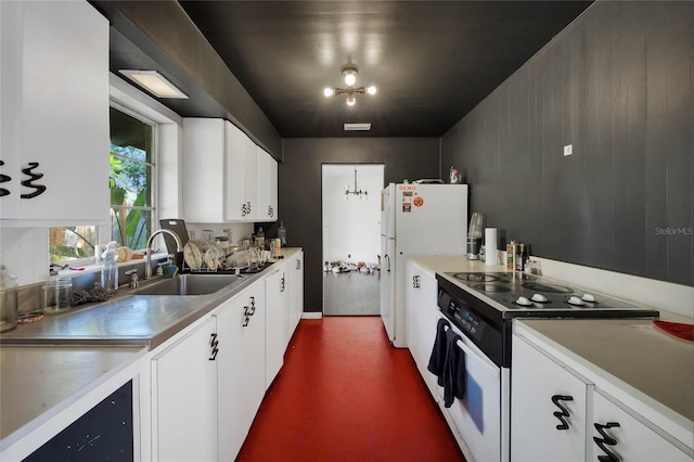 kitchen featuring white cabinets, white appliances, sink, and a chandelier