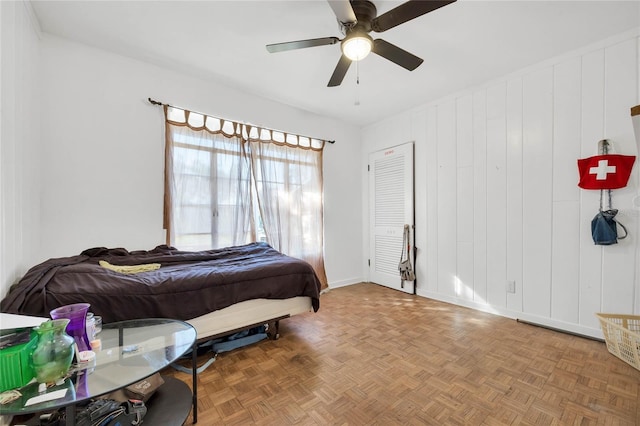 bedroom featuring ceiling fan and parquet floors