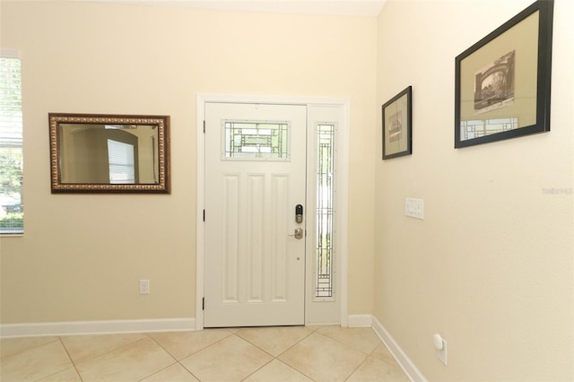 foyer entrance with light tile patterned floors