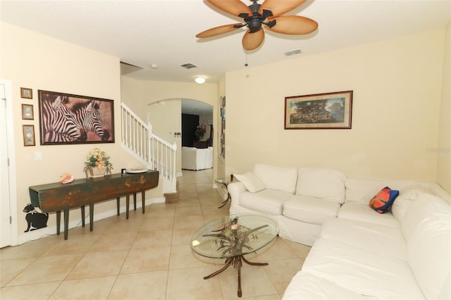 living room with ceiling fan and light tile patterned flooring