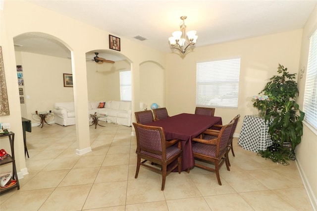 dining space featuring ceiling fan with notable chandelier and light tile patterned flooring