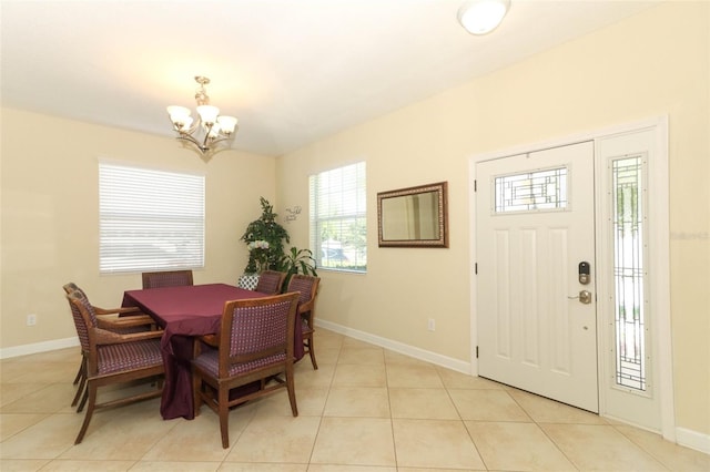 dining room featuring light tile patterned floors and an inviting chandelier