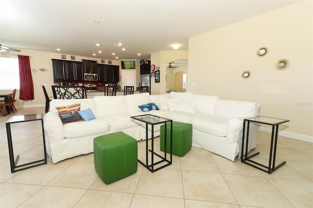 living room featuring ceiling fan and light tile patterned flooring