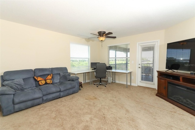 carpeted living room featuring ceiling fan