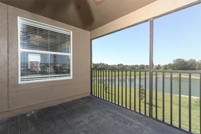 unfurnished sunroom featuring a water view