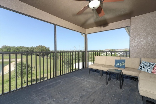 unfurnished sunroom featuring a water view and ceiling fan