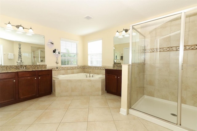 bathroom with tile patterned floors, vanity, and independent shower and bath