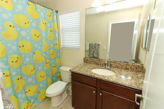 bathroom featuring toilet, vanity, and tile patterned floors