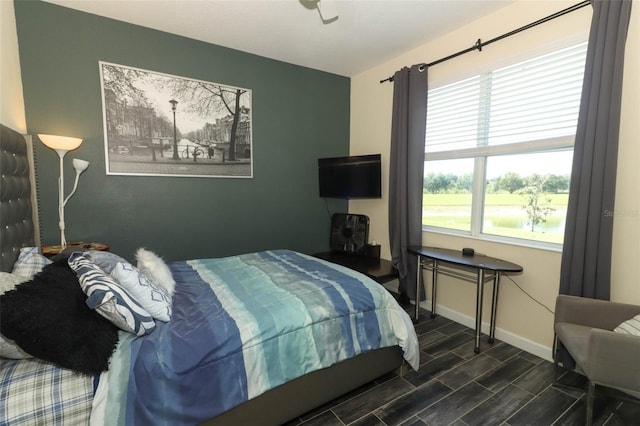 bedroom with dark hardwood / wood-style floors