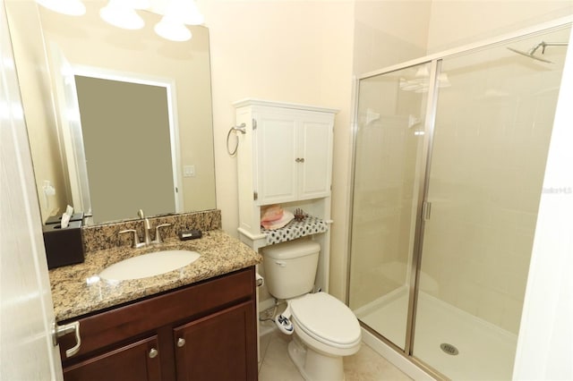 bathroom with tile patterned floors, a shower with door, vanity, and toilet