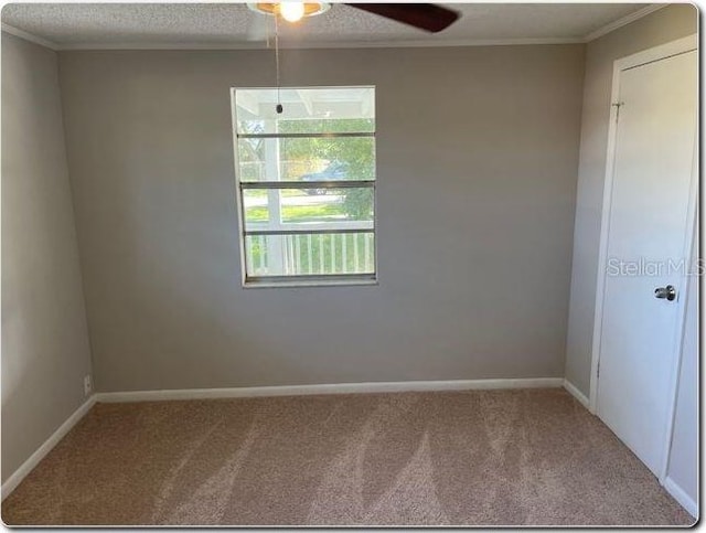 unfurnished room featuring crown molding, carpet, a textured ceiling, and ceiling fan