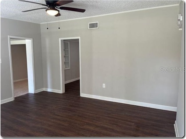 empty room featuring a textured ceiling, dark hardwood / wood-style floors, and ceiling fan