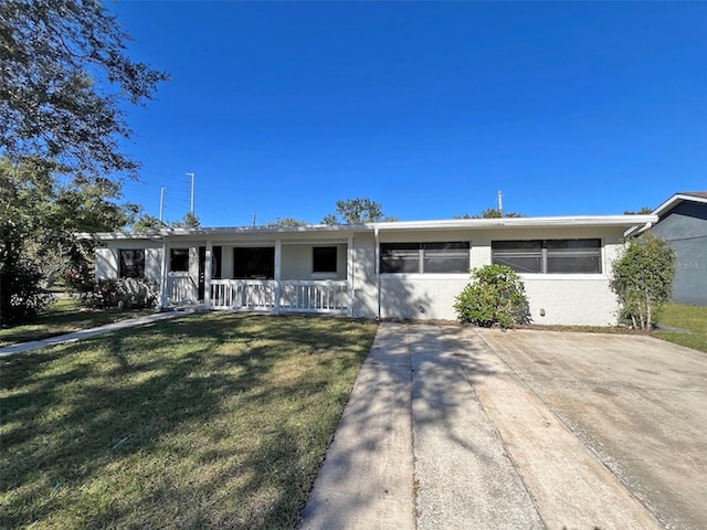 single story home with a porch and a front lawn