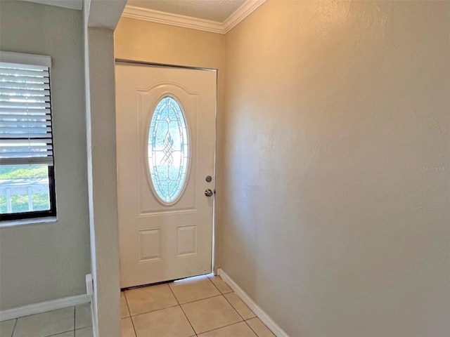 entryway with ornamental molding and light tile patterned flooring