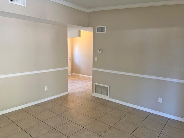 tiled spare room with ornamental molding