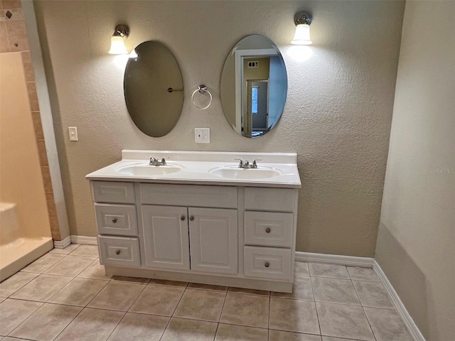 bathroom featuring a shower, vanity, and tile patterned floors