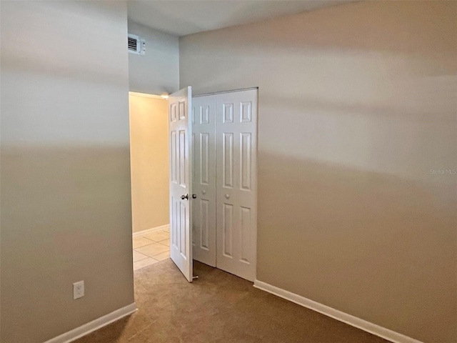 corridor with light colored carpet