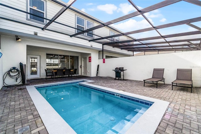 view of pool with a patio and a lanai