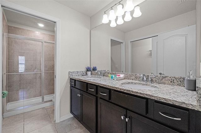 bathroom featuring vanity, tile patterned floors, toilet, and walk in shower