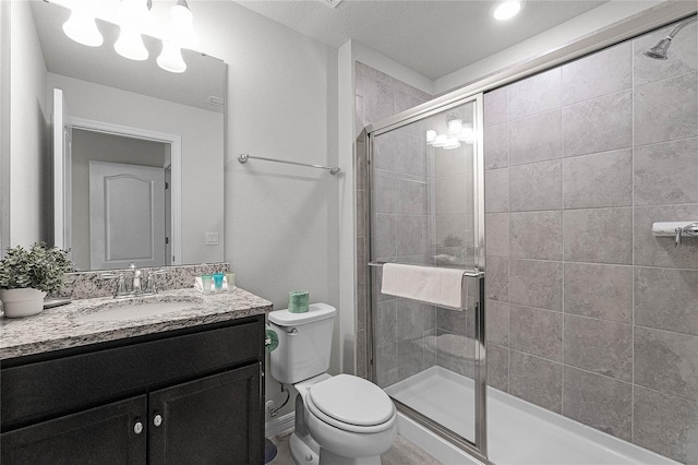 bathroom with vanity, toilet, and an enclosed shower