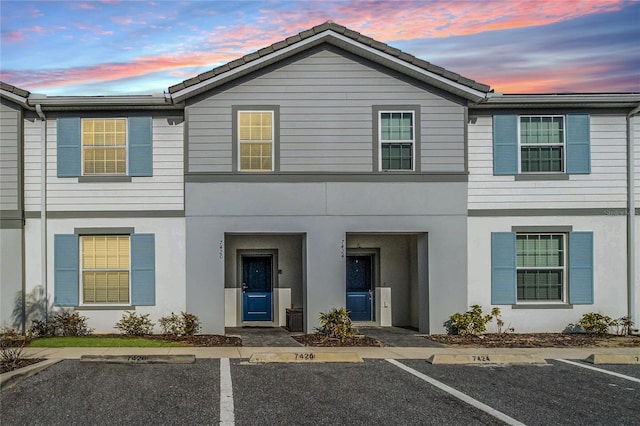 7420 Oakmoss Loop, Davenport, FL 33837 - townhome / multi-family property with uncovered parking and stucco siding