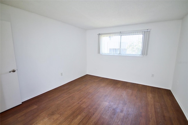 unfurnished room featuring dark hardwood / wood-style floors