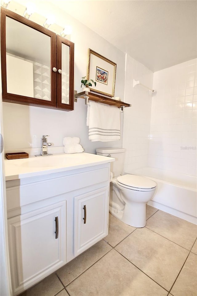 full bathroom featuring tile patterned floors, vanity, toilet, and tiled shower / bath combo