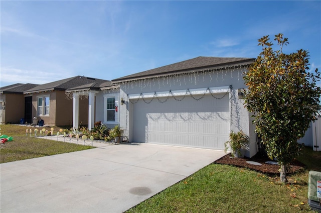 view of front of house with a front yard and a garage