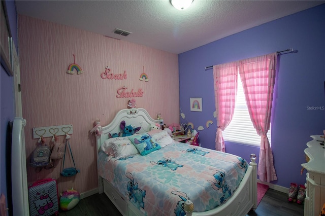 881 Orchid Grove Blvd, Davenport, FL 33837 - bedroom featuring wood finished floors and a textured ceiling