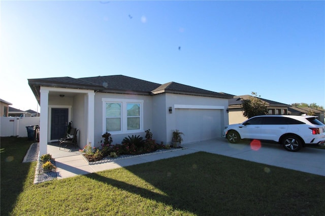 view of front of house with an attached garage, stucco siding, concrete driveway, and a front yard