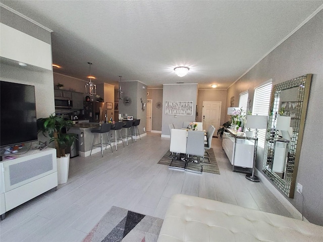 881 Orchid Grove Blvd, Davenport, FL 33837 - dining space featuring light wood finished floors and a textured ceiling