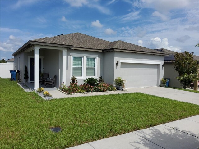 881 Orchid Grove Blvd, Davenport, FL 33837 - view of front of property featuring stucco siding, a garage, a front lawn, driveway, and a shingled roof