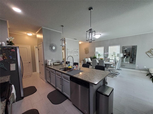 881 Orchid Grove Blvd, Davenport, FL 33837 - kitchen featuring appliances with stainless steel finishes, a textured ceiling, hanging light fixtures, stone countertops, and open floor plan