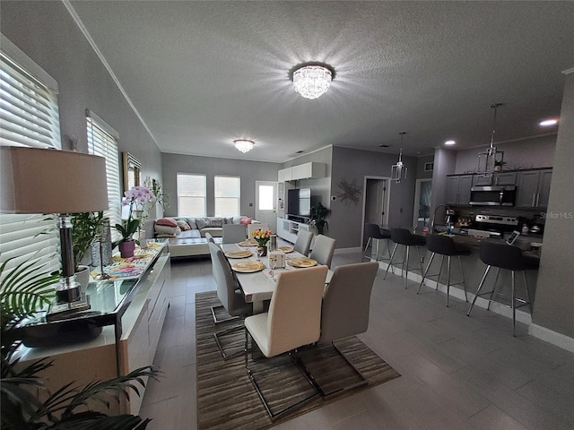 881 Orchid Grove Blvd, Davenport, FL 33837 - dining room with wood finished floors, a textured ceiling, and a chandelier