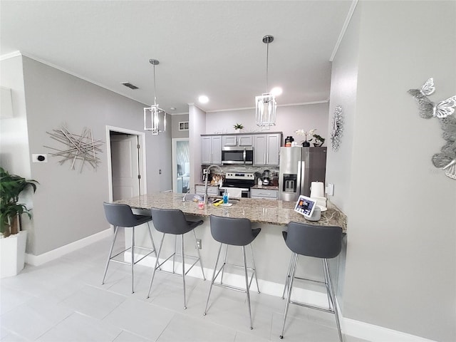 881 Orchid Grove Blvd, Davenport, FL 33837 - kitchen with appliances with stainless steel finishes, a kitchen bar, backsplash, light stone countertops, and ornamental molding
