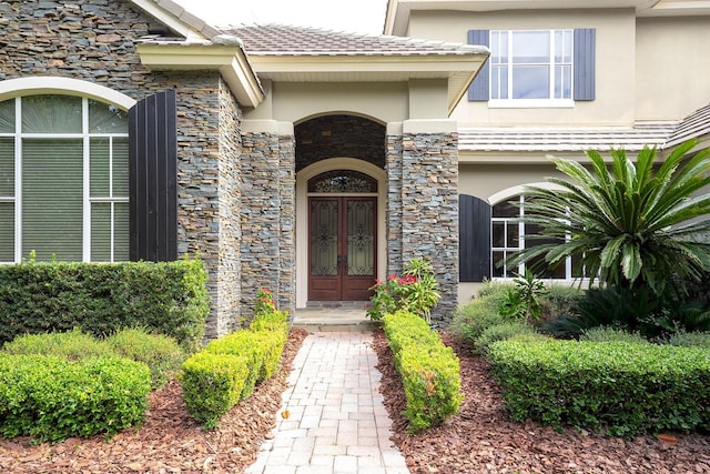 view of exterior entry featuring french doors