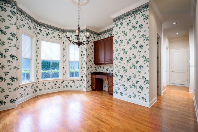 interior space featuring a chandelier, light hardwood / wood-style flooring, and crown molding