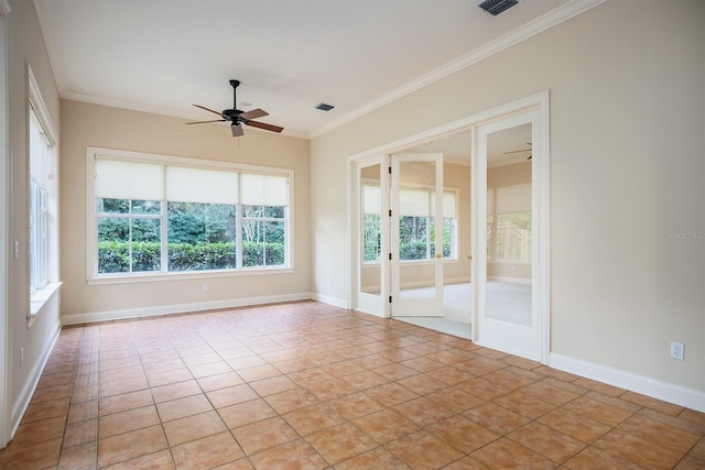 tiled empty room featuring ceiling fan and crown molding