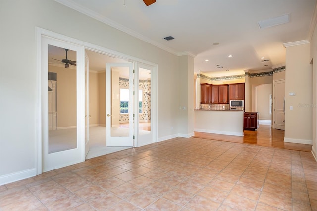 unfurnished living room with ceiling fan, light tile patterned floors, crown molding, and french doors