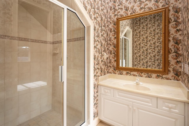 bathroom featuring vanity and an enclosed shower