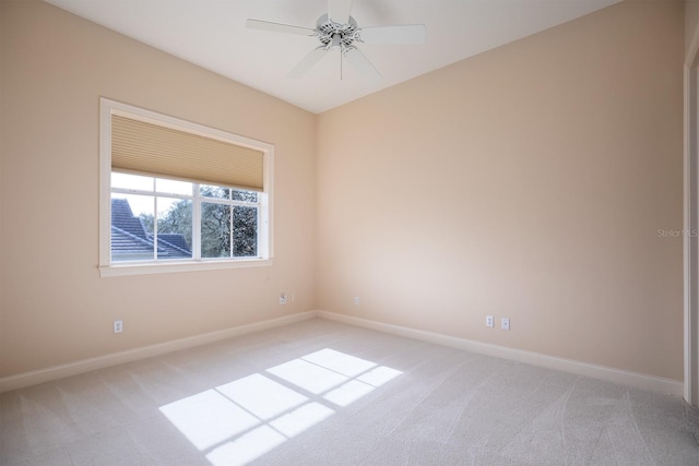 carpeted spare room with ceiling fan